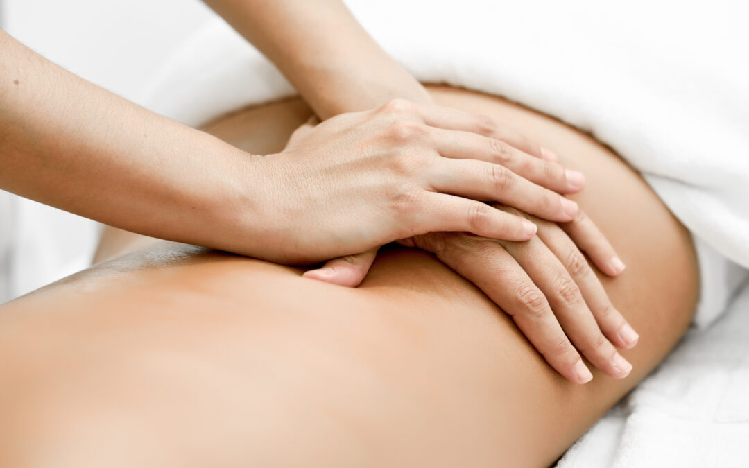 Young woman receiving a back massage in a spa center.